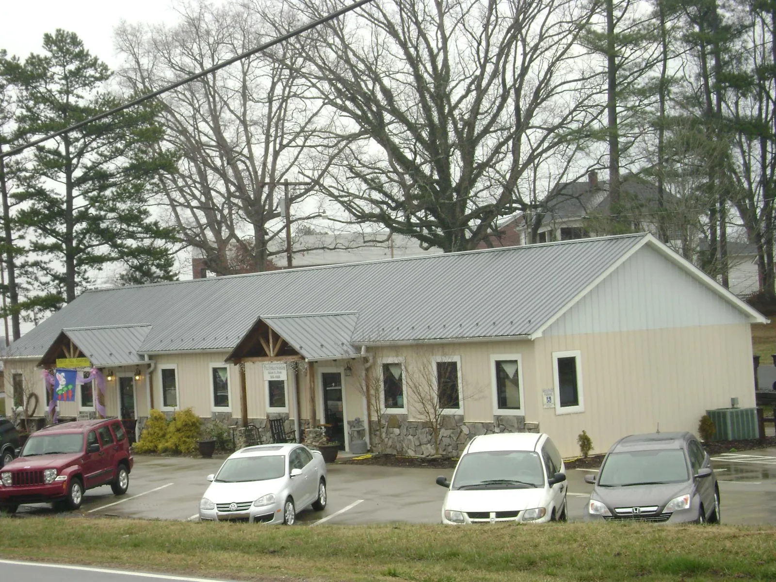 Gray metal roof with timber entry brackets on a small commercial building in Saint George